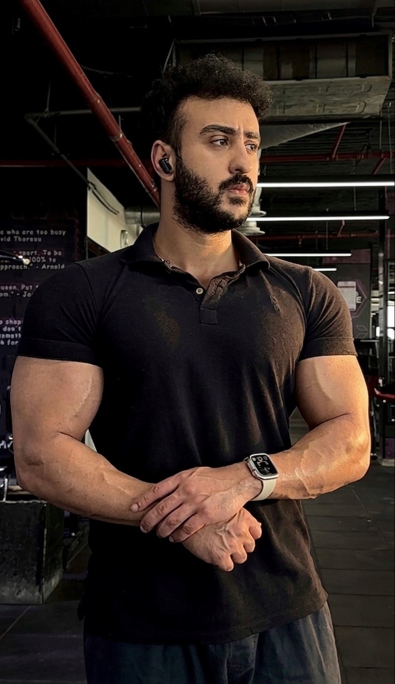 Dagher Mahmoud in a black polo shirt on the gym floor.